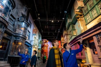 Visitors exploring the detailed Diagon Alley set at Warner Bros. Studios Japan