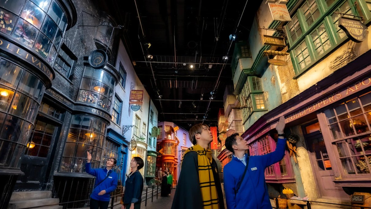 Visitors exploring the detailed Diagon Alley set at Warner Bros. Studios Japan