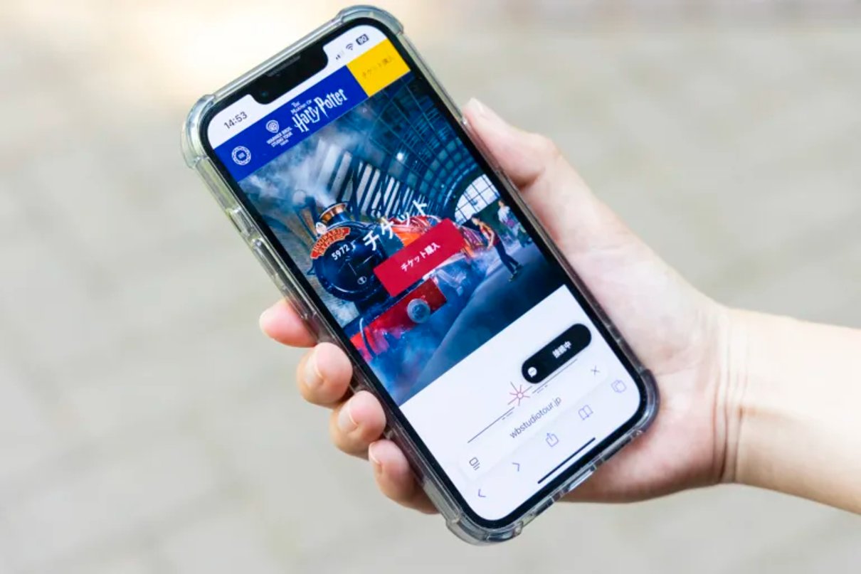 A phone displaying the Warner Bros. Studios Japan Digital Guide page