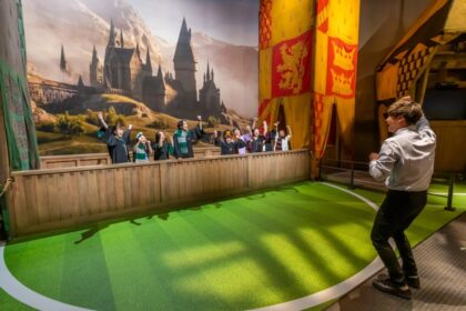 A visitor taking part in the Quidditch broom experience